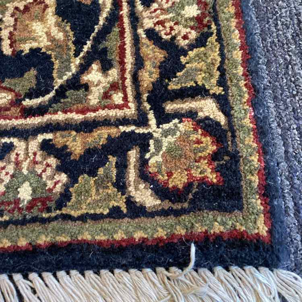 Black, Tan, Green, and Rust Rug