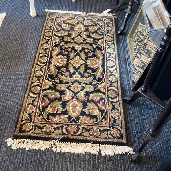 Black, Tan, Green, and Rust Rug